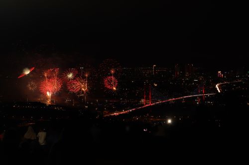 Free Night view of fireworks over İstanbul with Bosphorus Bridge illuminated, creating a dazzling cityscape. Stock Photo