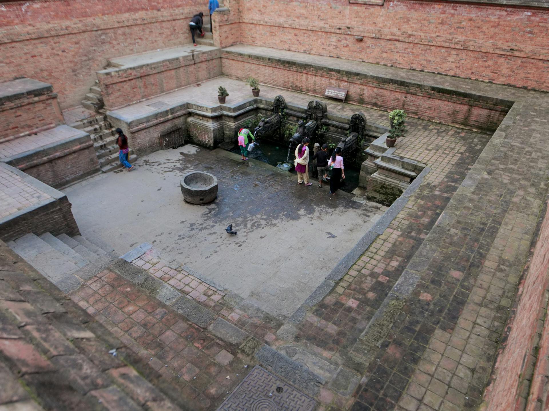 People Standing on Gray Concrete Brick Floor