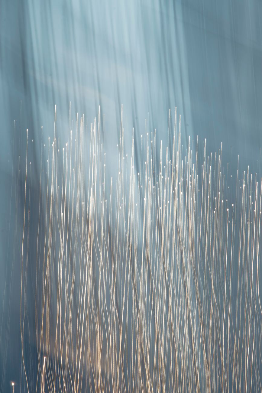 Glowing fiber optic strands carrying data between systems