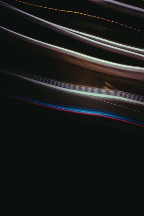 Free Dynamic light trails create an abstract pattern against a black background. Stock Photo