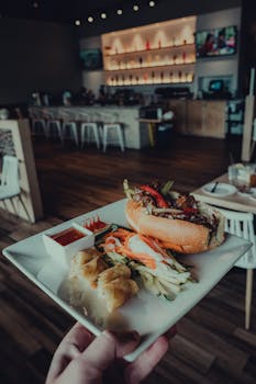 A plate of banh mi and spring rolls in a cozy indoor restaurant setting.