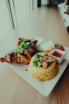 Tasty Asian-inspired chicken with fried rice and sauce, perfect for dining.