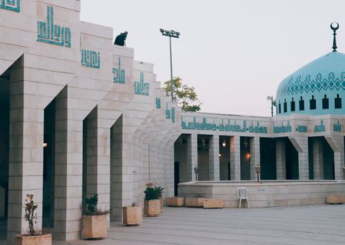 Free Beautiful mosque exterior in Amman, Jordan showcasing Ottoman architecture with a striking blue dome. Stock Photo