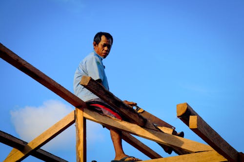 Carpenter Cutting a Roof Frame