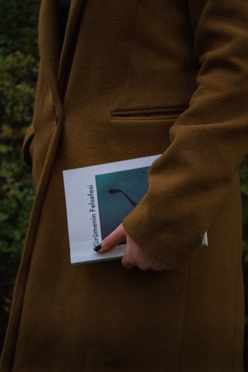 A Close-Up Shot of a Woman Holding a Book