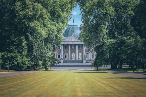 Free View of the Royal Palace of Laeken amidst lush gardens in Brussels, Belgium. Stock Photo