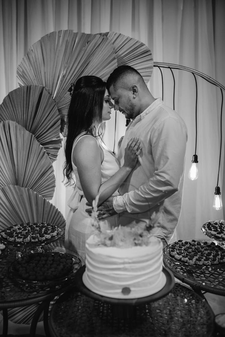 Bride And Groom Near Wedding Cake