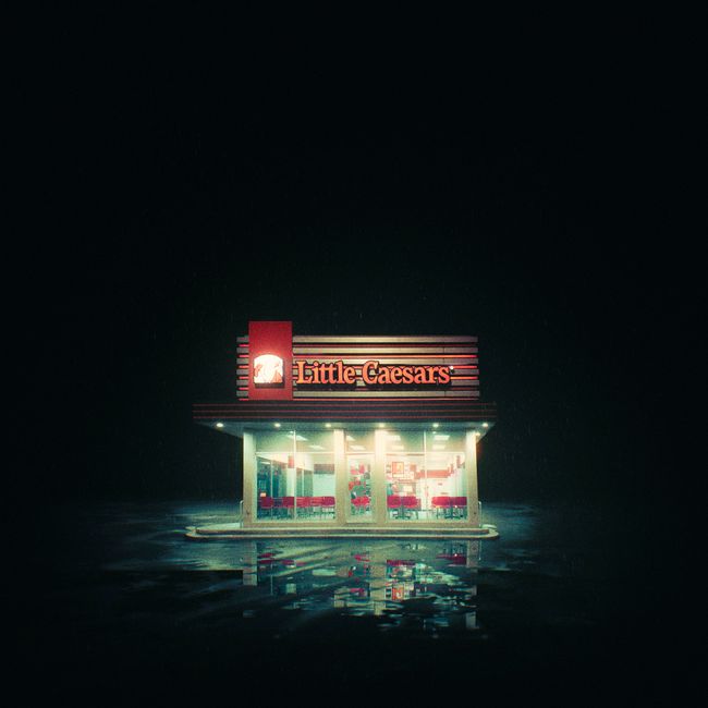 A brightly lit Little Caesars restaurant at night in Nuevo Laredo, Mexico.
