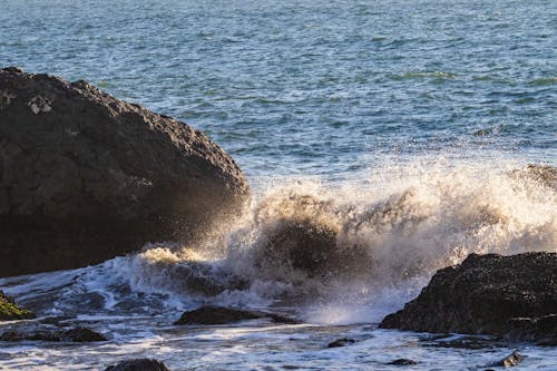  Waves Crashing on Rock Formation