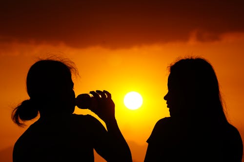 Silhouette of Women During Sunset