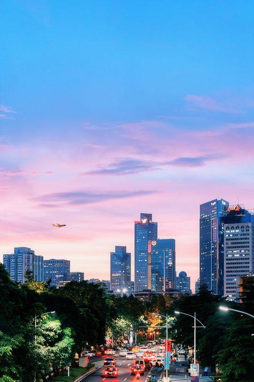 Free Vibrant Guangzhou cityscape at twilight with illuminated skyscrapers and bustling traffic, capturing urban life. Stock Photo