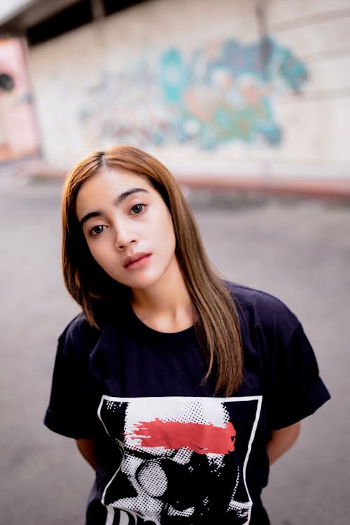 Woman in Black T-shirt Holding Posing on the Street