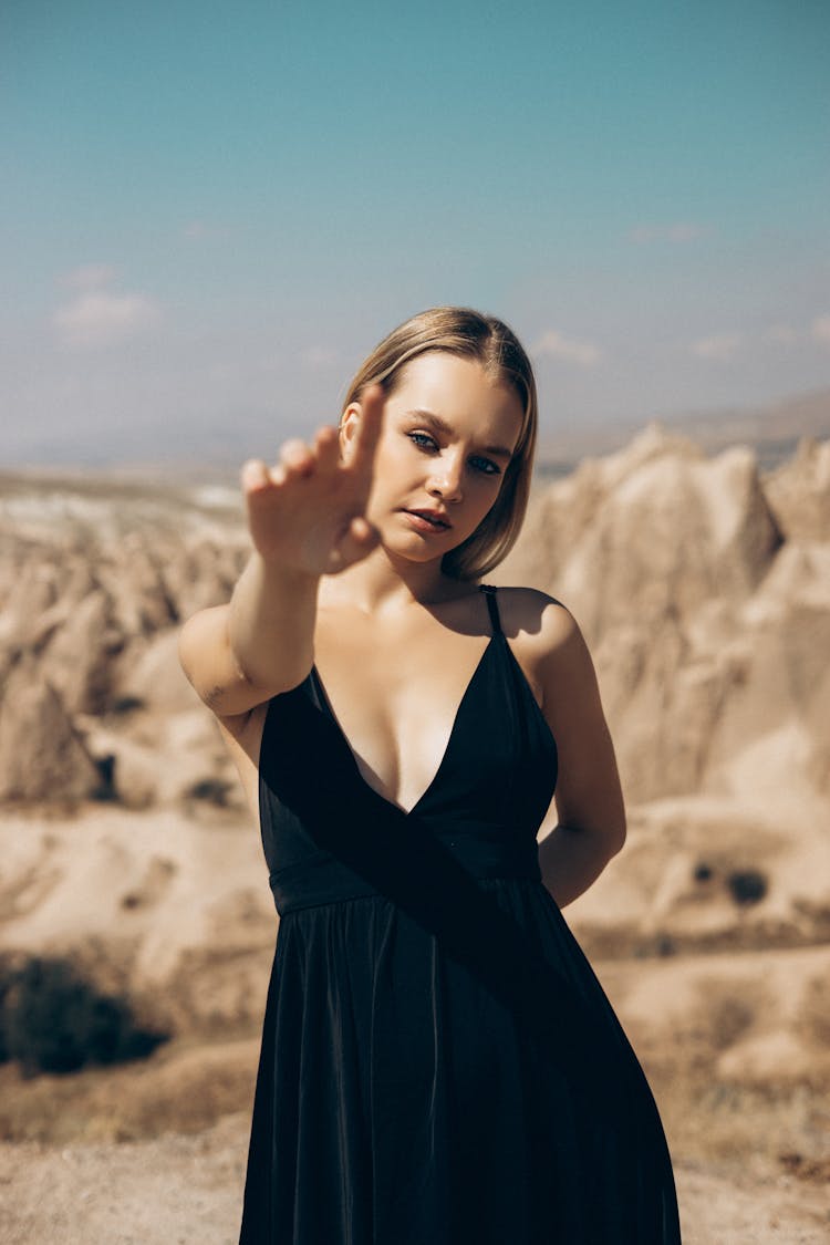 Woman In Black Dress Reaching Her Hand