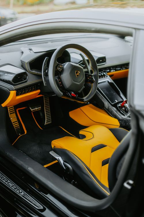 Free Explore the sleek design and opulent leather of a Lamborghini Huracan sports car interior with vibrant yellow accents. Stock Photo