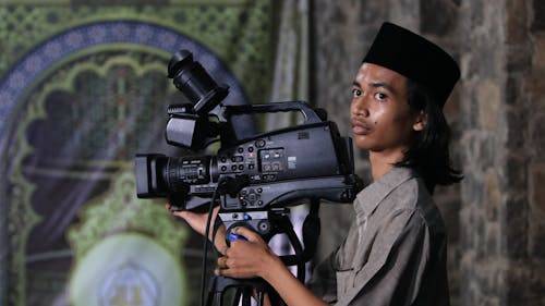 Young Man Operating a Professional Camera 