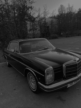 Elegant black vintage car parked outdoors, showcasing classic design and style.