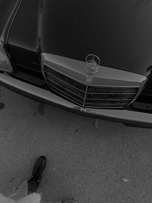 Free Black and white image of a classic Mercedes Benz car hood with emblem. Stock Photo