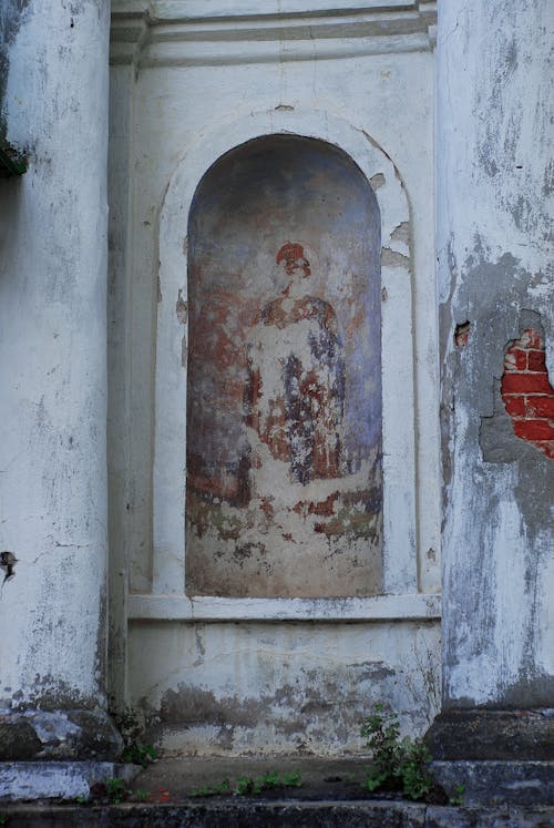 Destroyed Facade of an Old Building with Architectural Details 