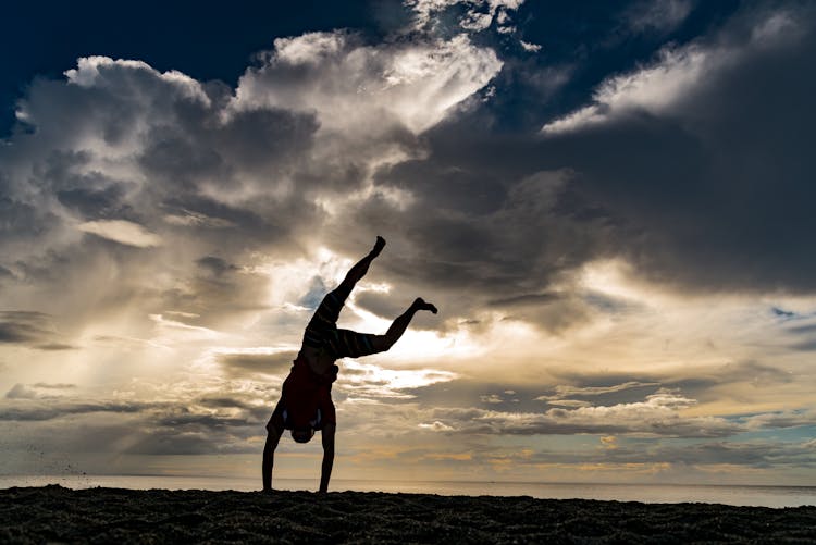 Hand Walking Person Against Clouds