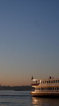 Scenic view of a ferry boat on the Bosphorus at sunset in Istanbul, Turkey.