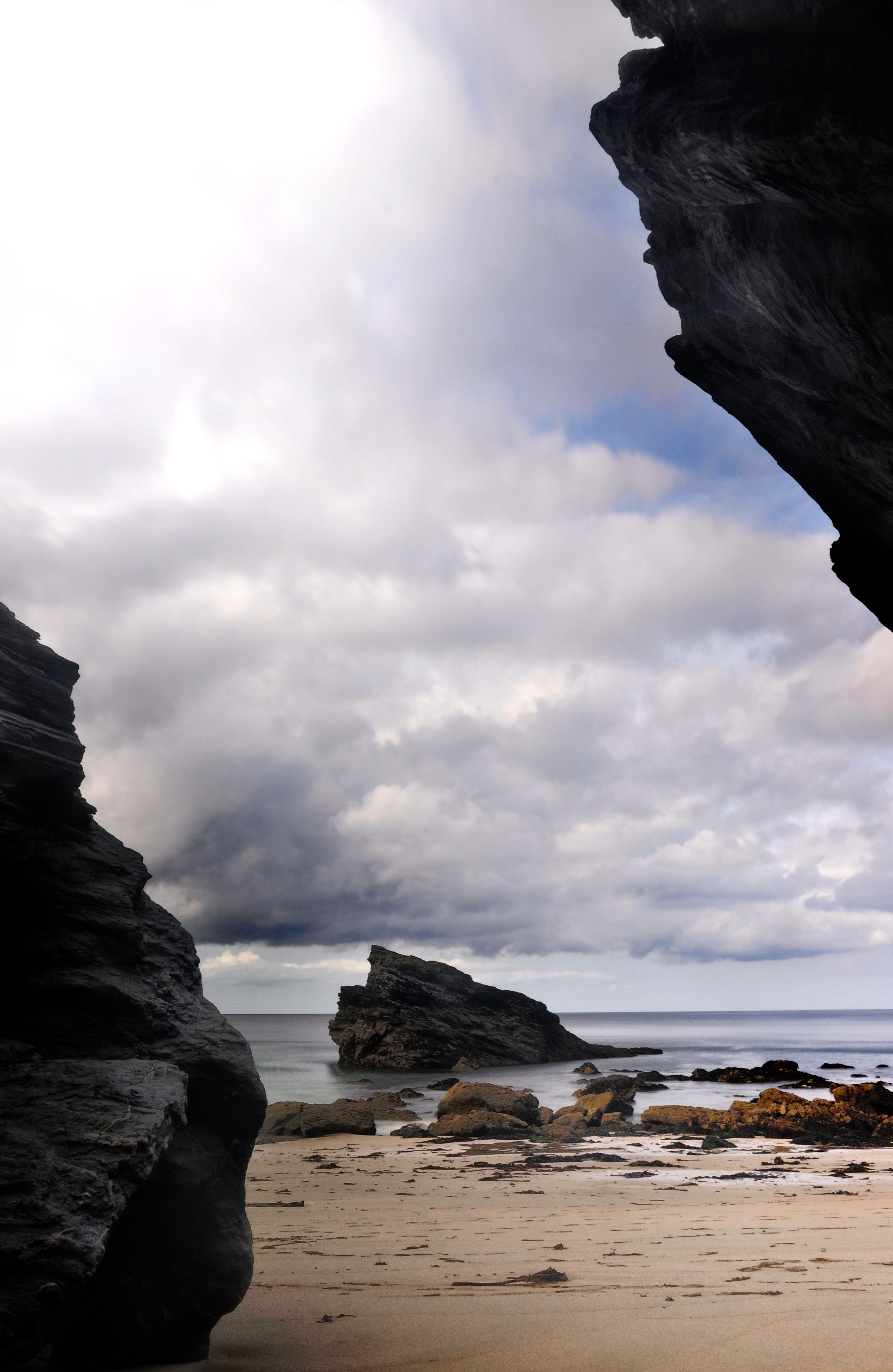 Rocks on Shore Under White Clouds and Blue Sky · Free Stock Photo