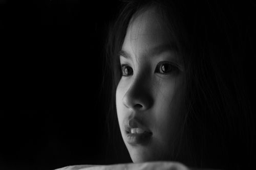 Free Close-up black and white portrait of a young girl with expressive eyes. Stock Photo