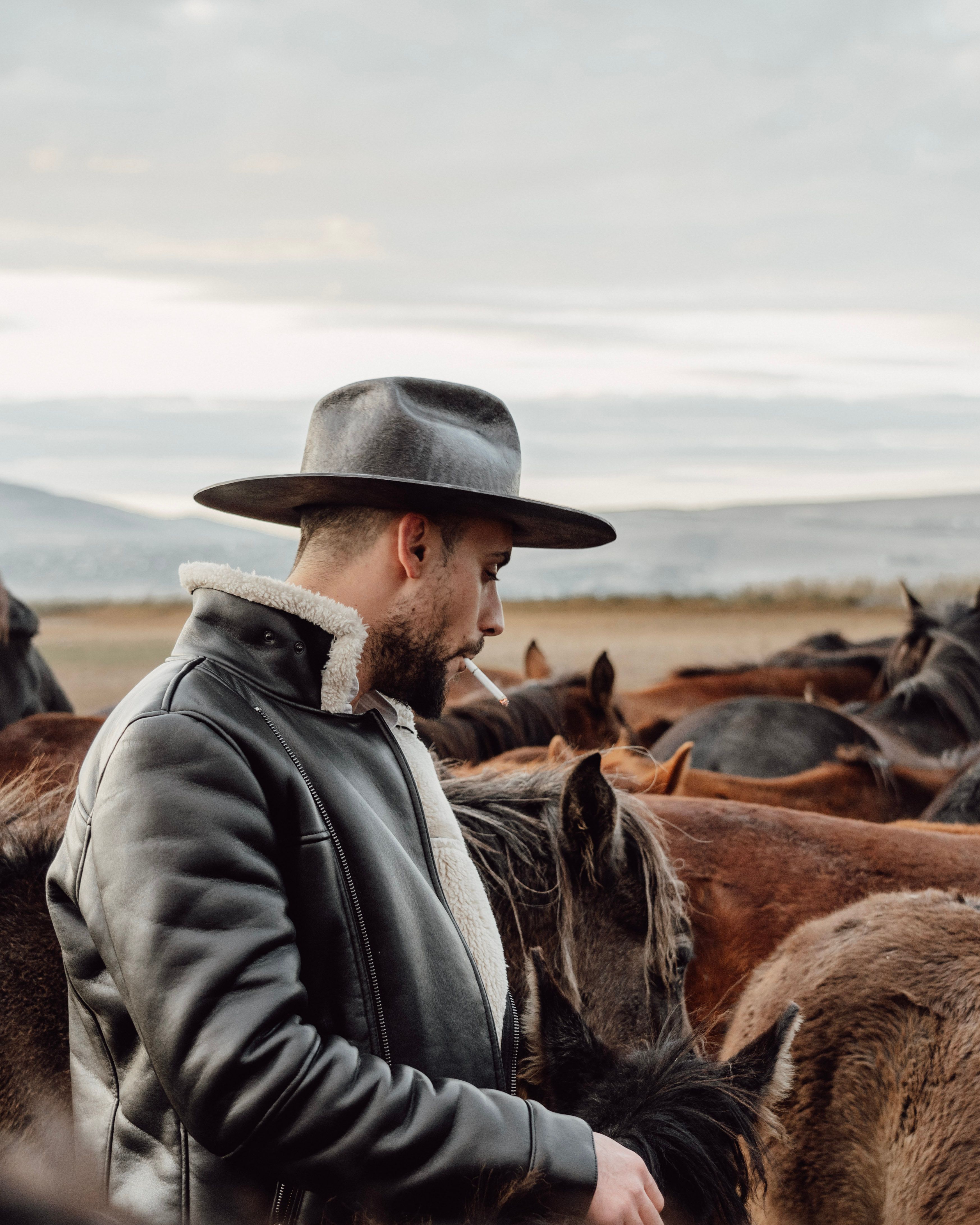 A Man Wearing a Hat and Black Leather Jacket · Free Stock Photo