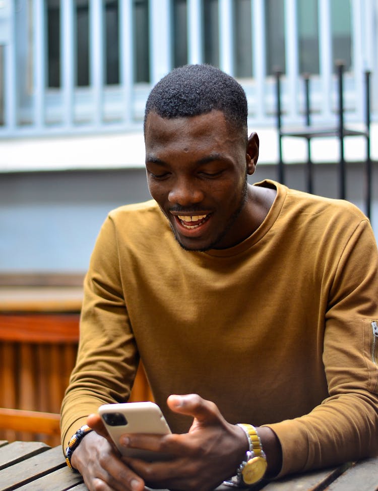 Man Smiling To Cellphone