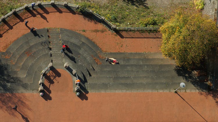 Man Lying On Steps In An Urban Park