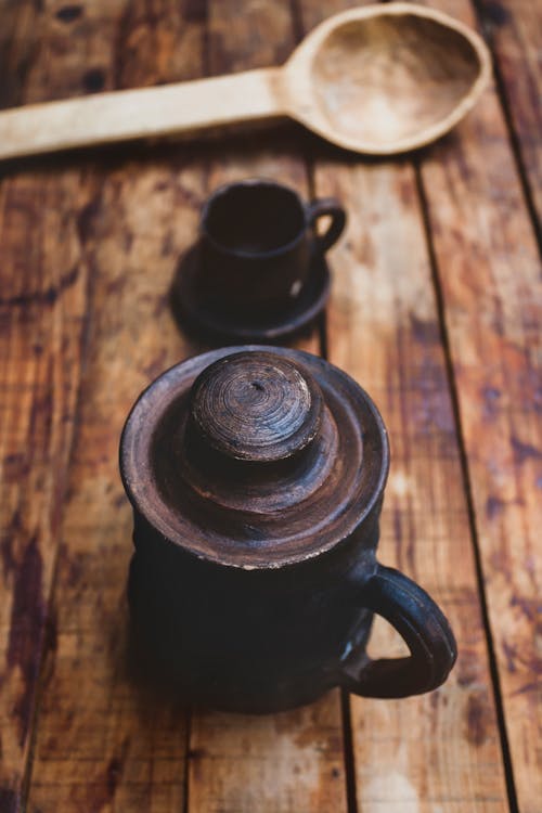 A Rustic Coffee Pot on a Wooden Surface
