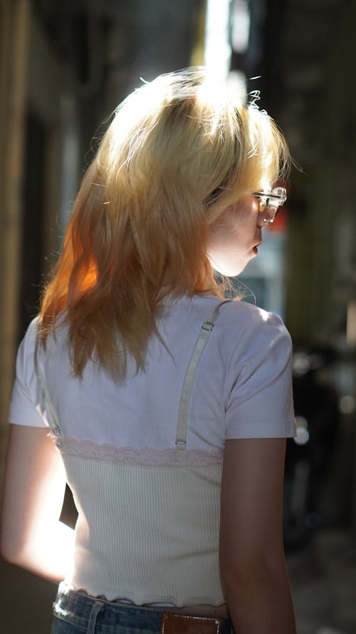 A Blonde Haired Woman in White Shirt Wearing Eyeglasses