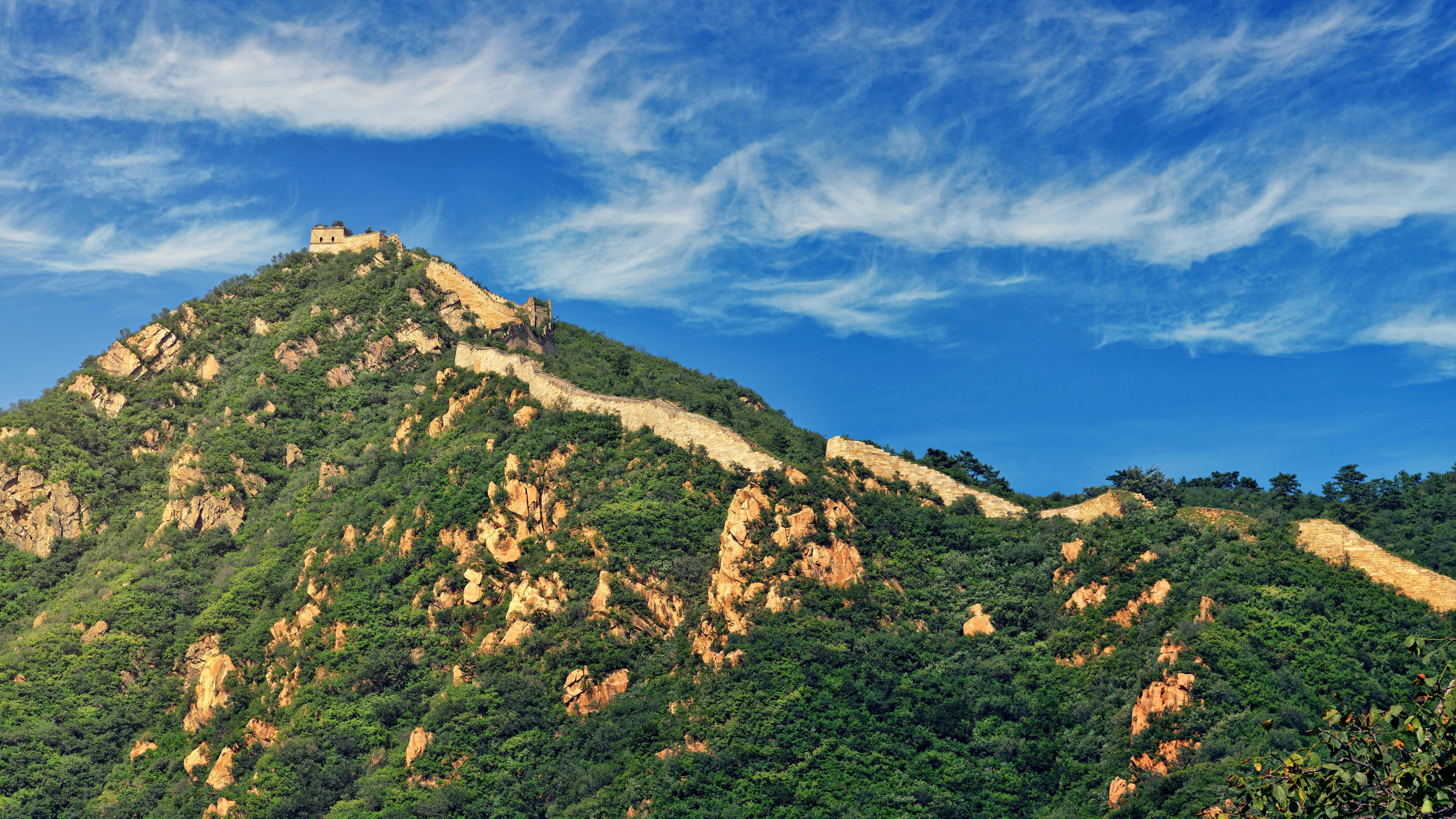 green hills under alto cirrus clouds