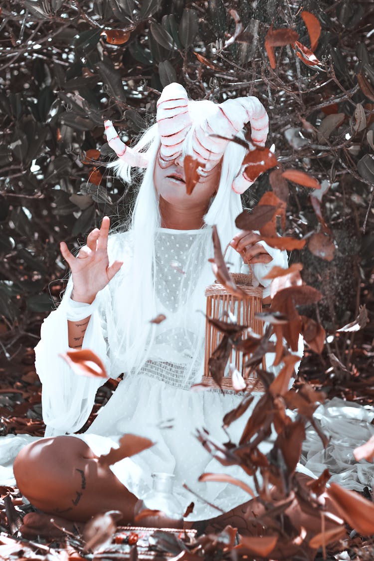 Woman In White Dress Wearing Mask With Horns