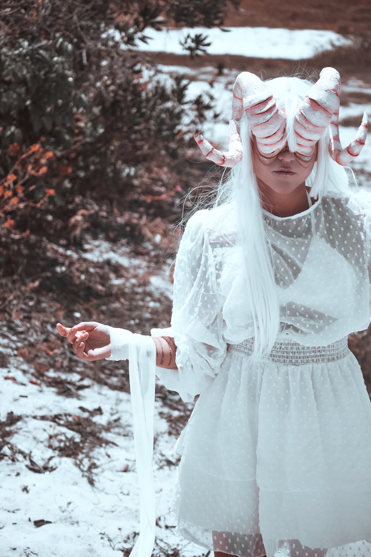 Woman With Creative Horns Mask In Winter Nature