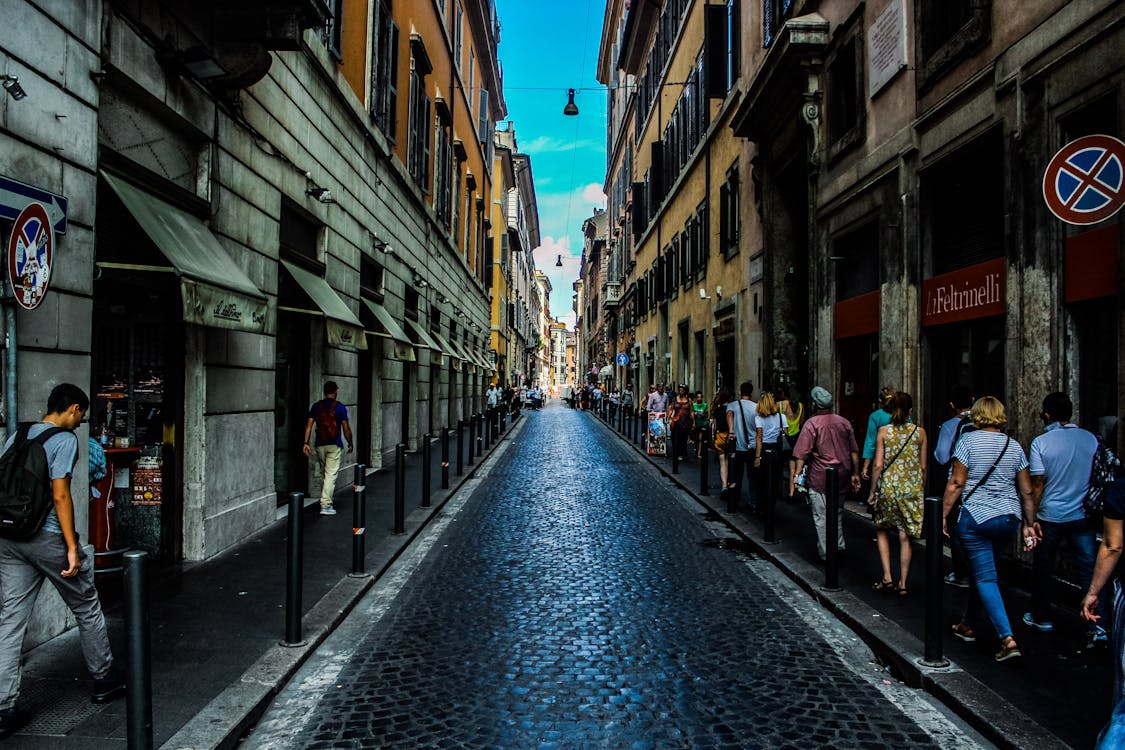 People Walking on Sidewalk Beside Road