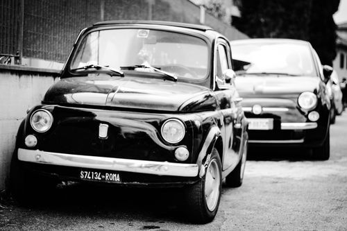 Free Black and white photo of two classic Fiat cars parked outdoors in Rome. Stock Photo