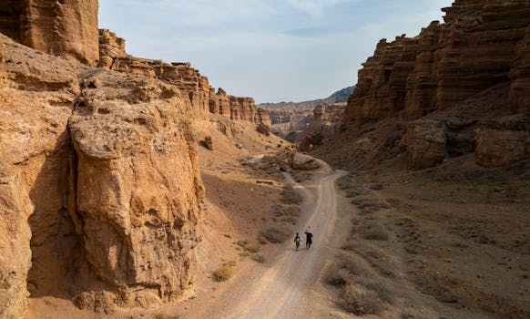 Two people walking through the stunning Charyn Canyon in Kazakhstan.
