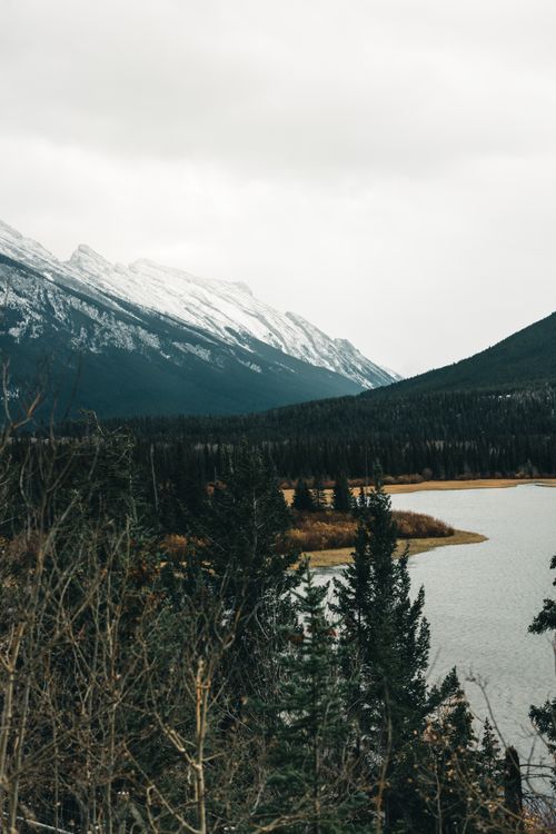 Free Snow-covered mountains and a serene lake in Banff National Park, Alberta, Canada. Stock Photo