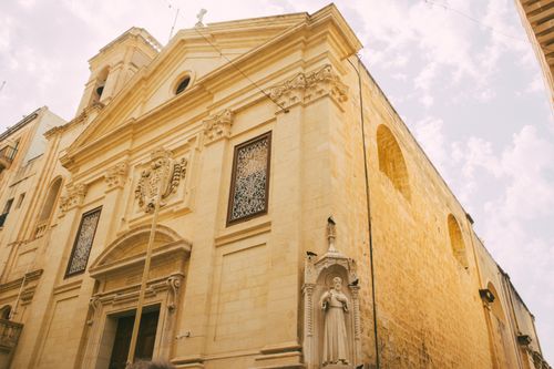 Free A stunning historic church with classic architecture in Valletta, Malta, capturing its sacred sandstone beauty. Stock Photo