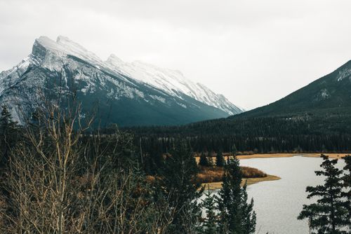 Free Beautiful snowy mountains and serene lake in Banff National Park, capturing the essence of autumn wilderness. Stock Photo