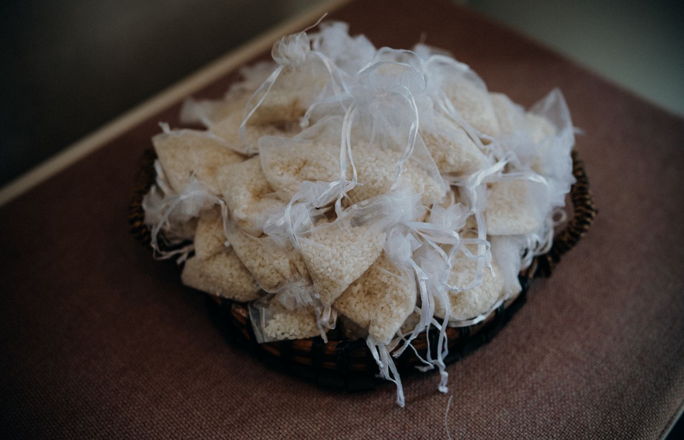 A collection of handmade rice sachets in decorative fabric bags for a rustic touch.