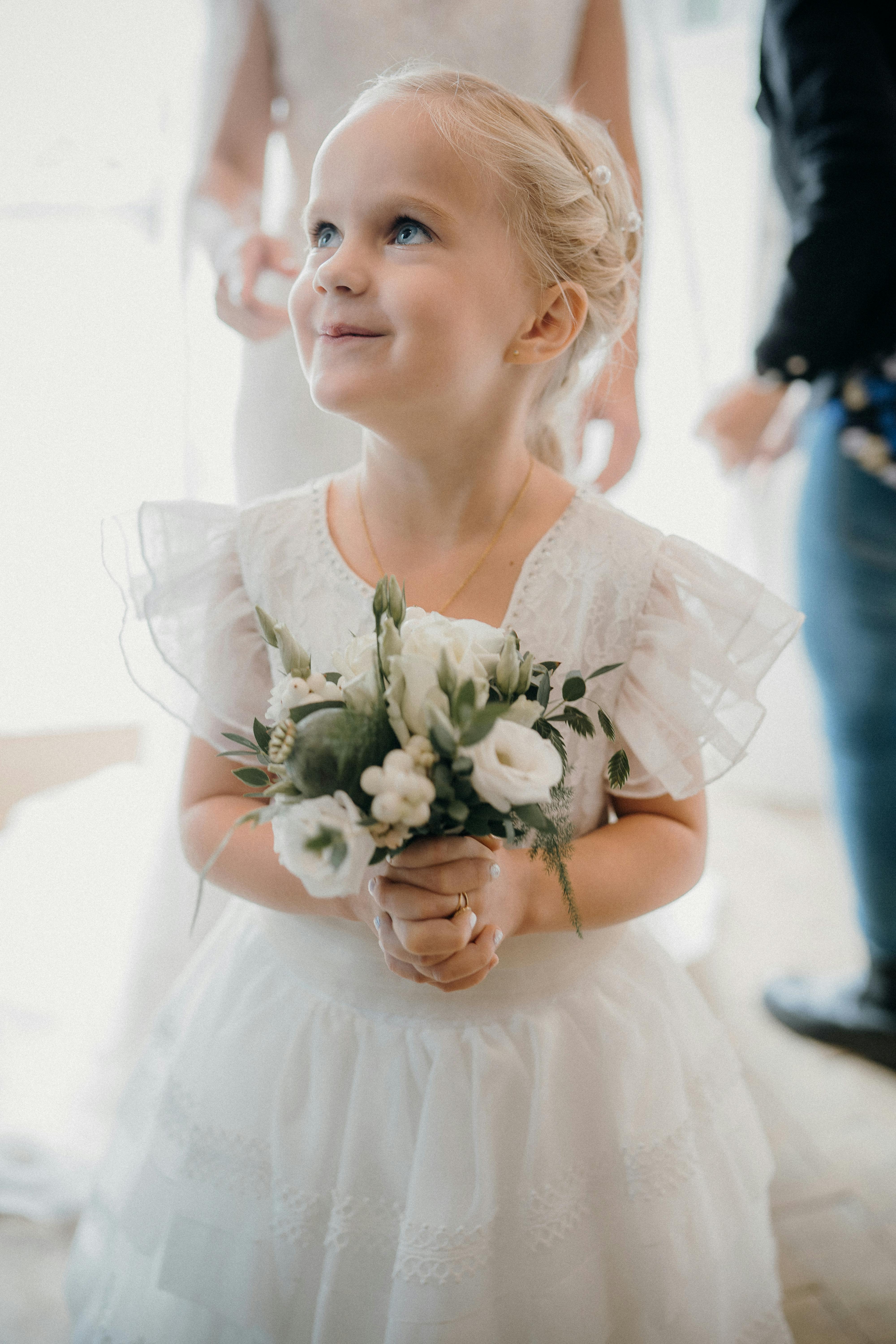 Flower Girl Holding a Bouquet · Free Stock Photo