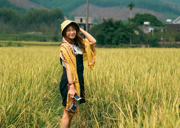 Woman In Black Jumper Standing On The Rice Field