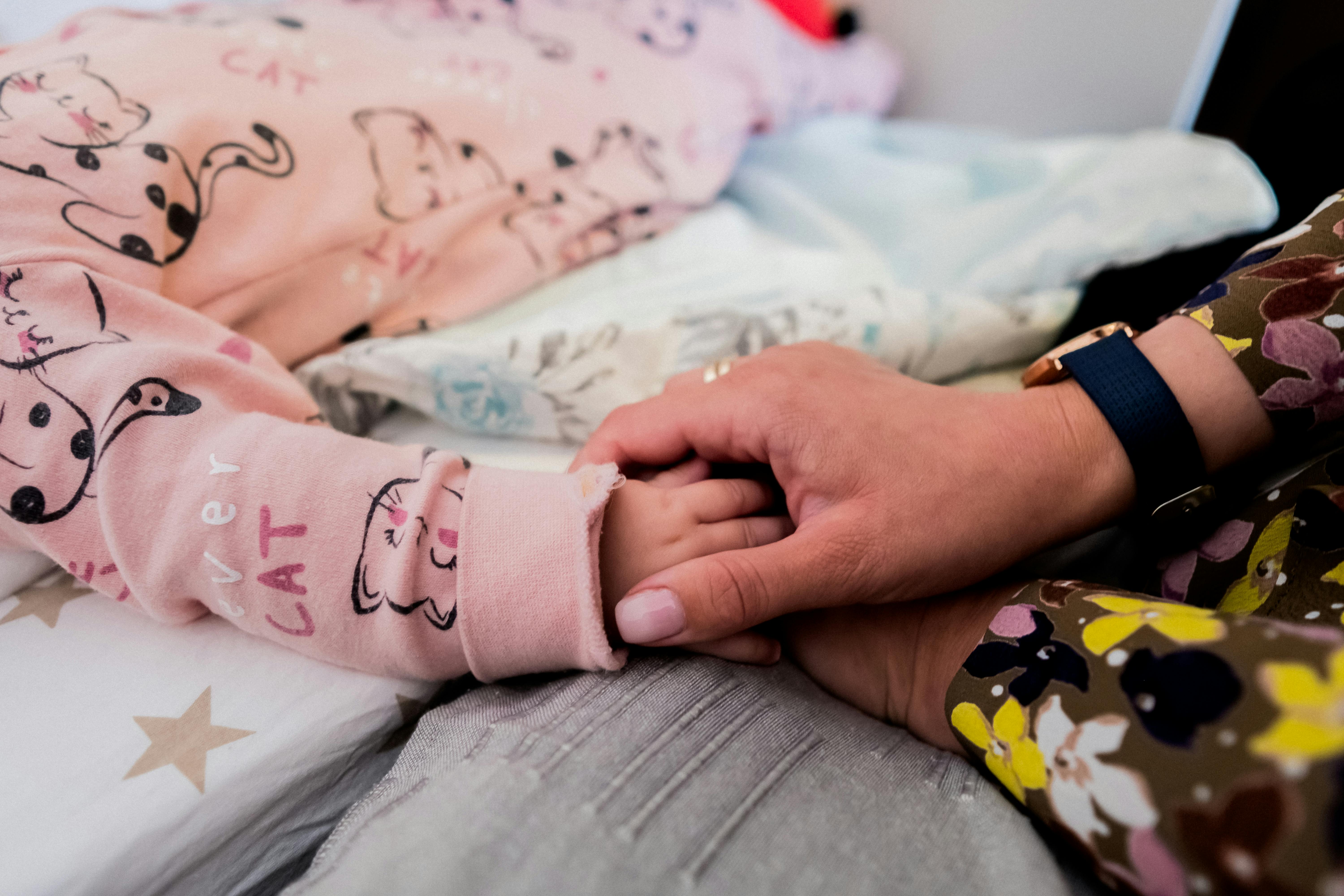 Mother Holding A Baby's Hand · Free Stock Photo