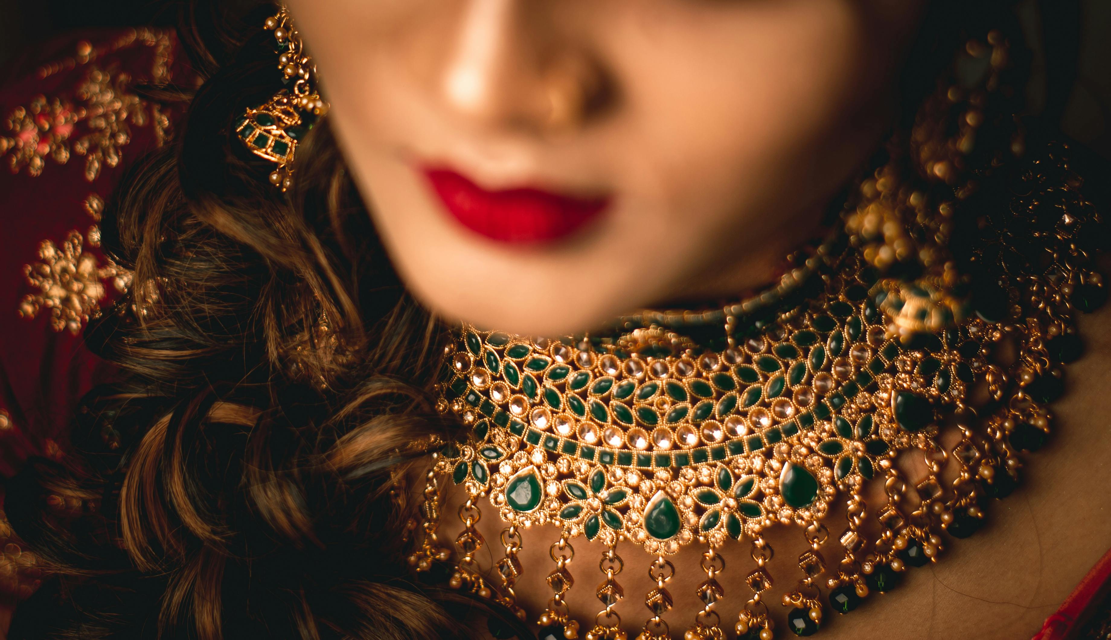 close up of golden jewelry on woman neck