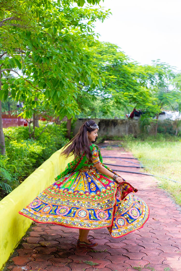 Woman Wearing A Colorful Dress Spinning Around