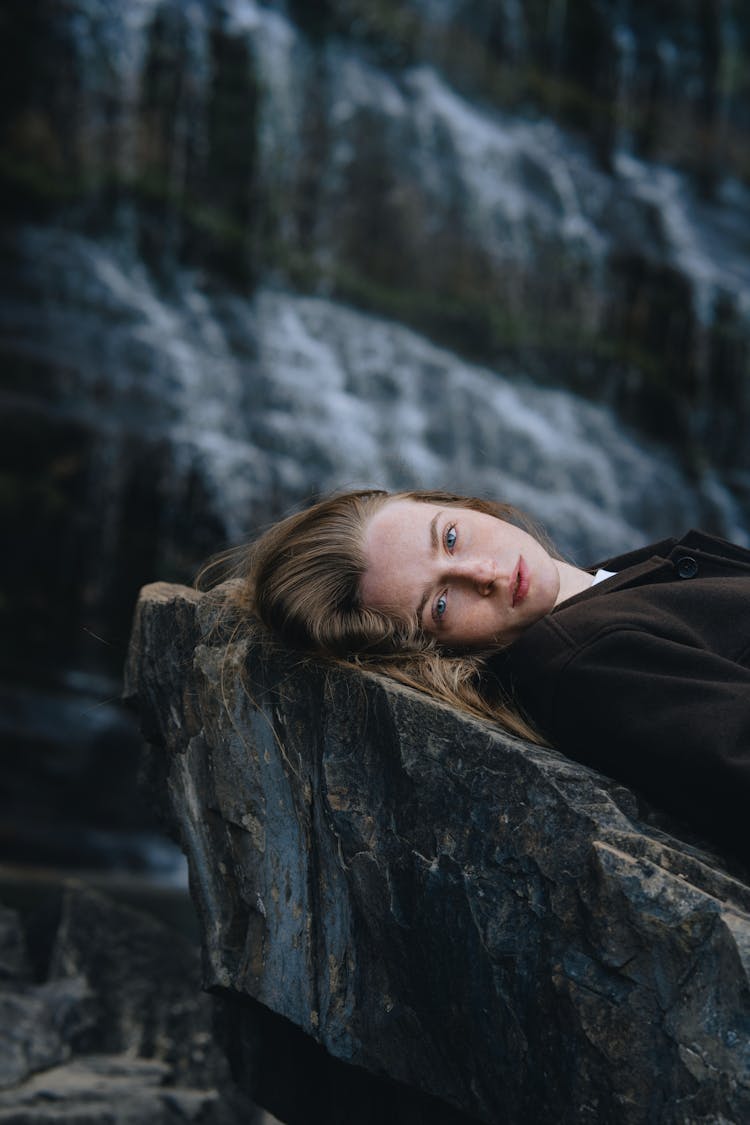 Woman Lying Down On Rock