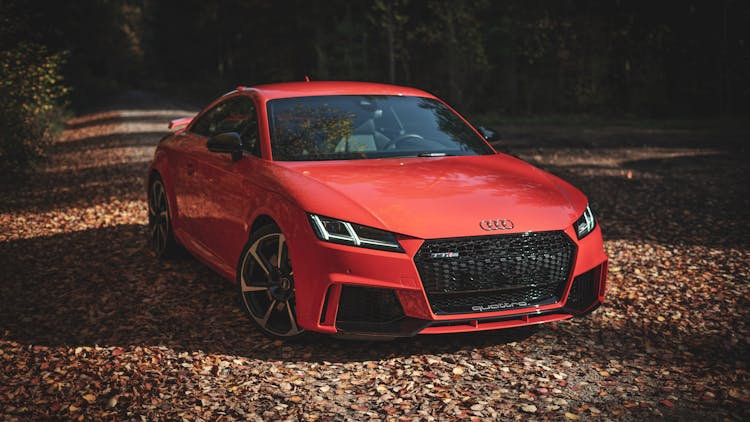 Red Sports Car Parked On Dirt Road