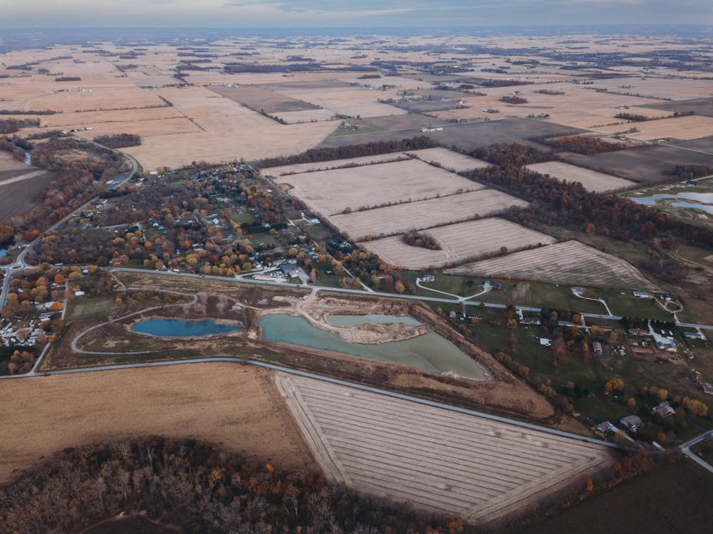 Aerial Shot of Cropland Surrounded by Trees 