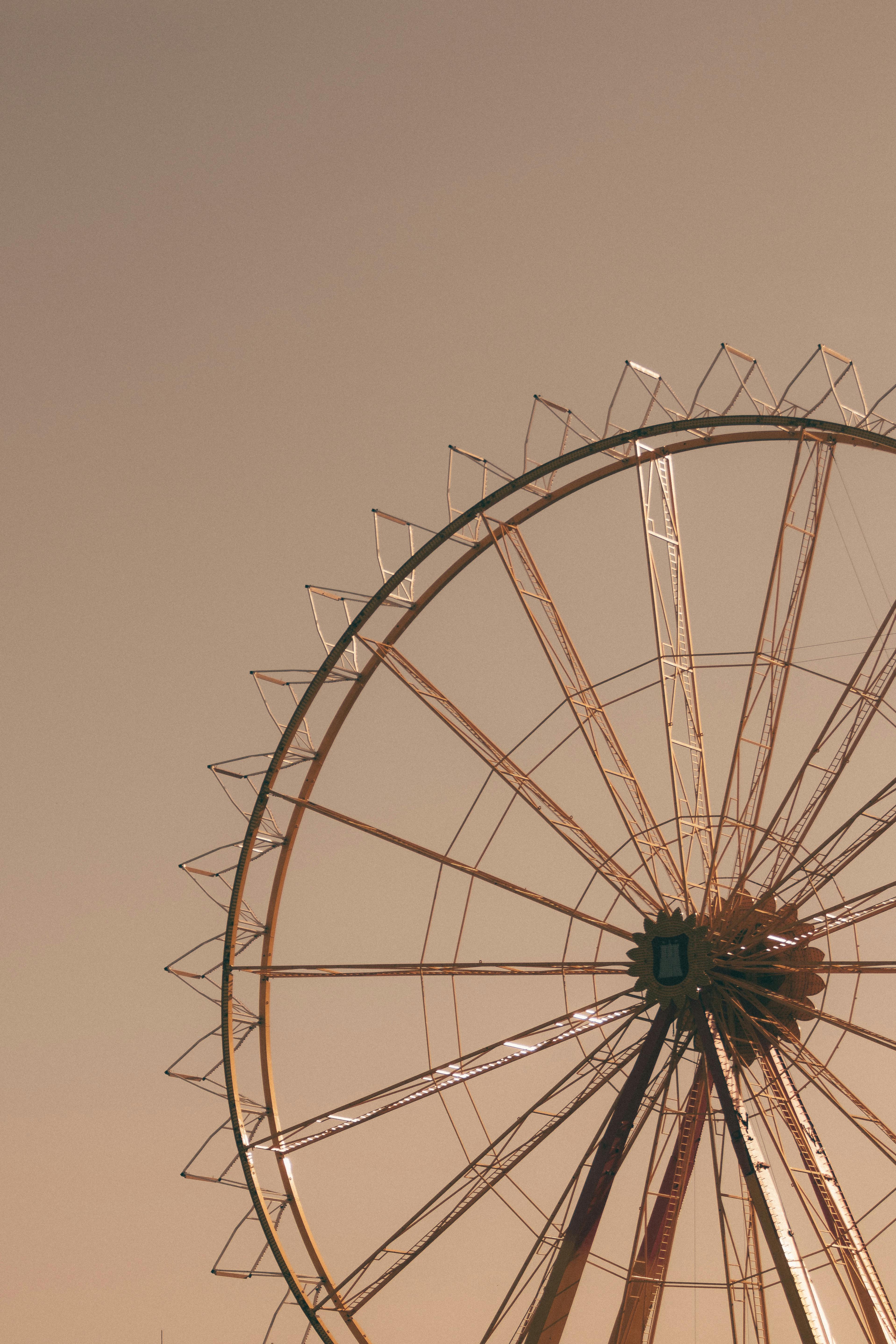 Ferris wheel silhouette against a warm sunset sky in Hamburg, Germany.
